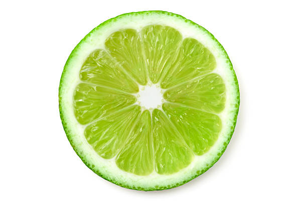 Lime slice A slice of lime on white background slice of food stock pictures, royalty-free photos & images