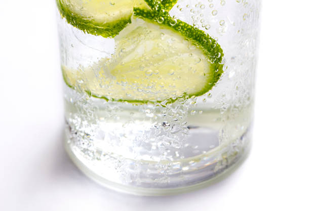 Lime slices, ice and soda in glass on white background.  vodka soda stock pictures, royalty-free photos & images