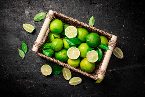 Lime with leaves in a basket. stock photo