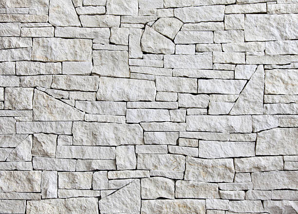 limestone wall - front view, many blocks - kalksteen stockfoto's en -beelden