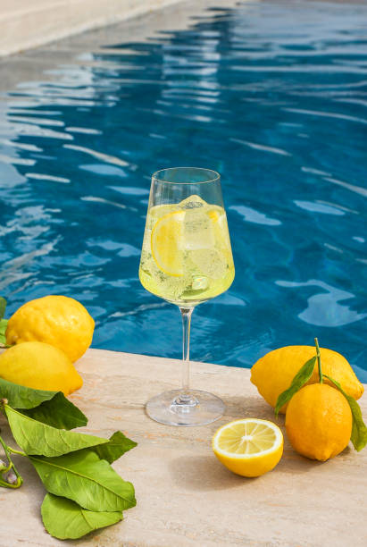 Limoncello Spritz Aperitif drink next to swimming pool with fresh Amalfi lemons stock photo