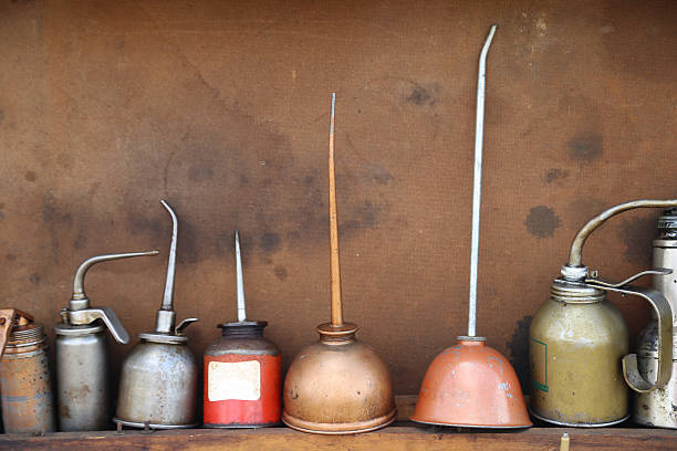 Line up of antique oil cans stock photo