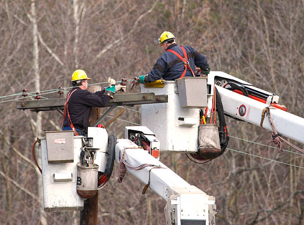 Line Workers Men working on pole repairing and moving lines from a cherry picker electricity pylon photos stock pictures, royalty-free photos & images