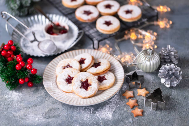 Linzer Christmas cookies filled with raspberry jam on concrete background stock photo