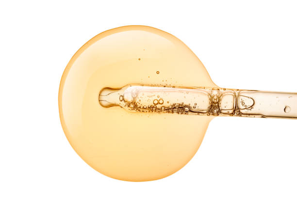 Liquid gel or serum with a pipette on white isolated background Liquid yellow gold gel or serum with a pipette on white isolated background essential oil stock pictures, royalty-free photos & images