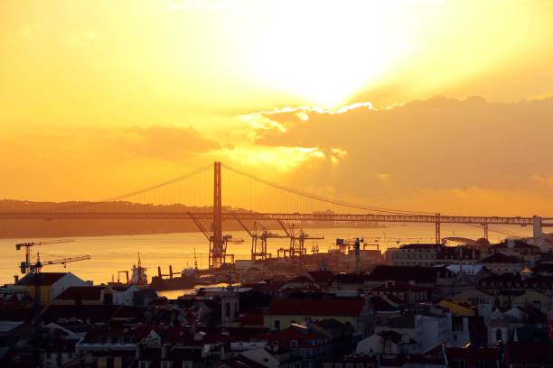 Lisbon city center and 25 de Abril Bridge at sunset. Portugal stock photo
