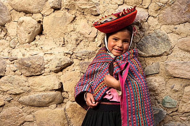Litte girl wearing national clothing, The Sacred Valley, Peru The Sacred Valley of the Incas or Urubamba Valley is a valley in the Andes  of Peru, close to the Inca capital of Cusco and below the ancient sacred city of Machu Picchu. The valley is generally understood to include everything between Pisac  and Ollantaytambo, parallel to the Urubamba River, or Vilcanota River or Wilcamayu, as this Sacred river is called when passing through the valley. It is fed by numerous rivers which descend through adjoining valleys and gorges, and contains numerous archaeological remains and villages. The valley was appreciated by the Incas due to its special geographical and climatic qualities. It was one of the empire's main points for the extraction of  natural wealth, and the best place for maize production in Peru.http://bem.2be.pl/IS/peru_380.jpg peru girl stock pictures, royalty-free photos & images