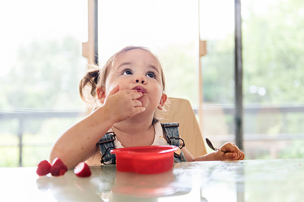 Little 2 years old girl eating jello babay eating stock pictures, royalty-free photos & images