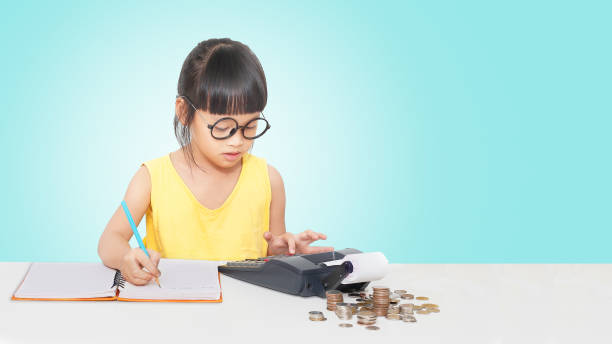 Little accountant Little girl use caculator and note for money. Clipping path. counting stock pictures, royalty-free photos & images