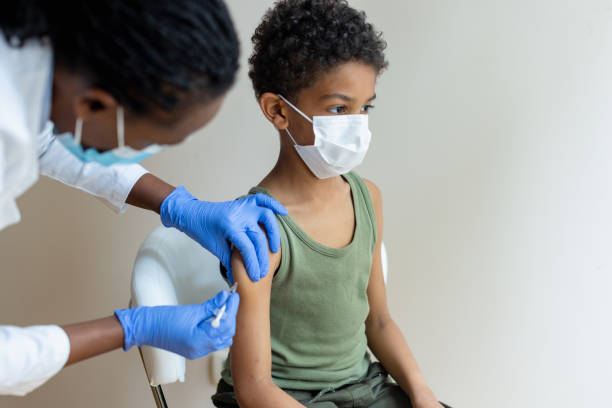 Little African-American boy COVID-19 vaccination stock photo