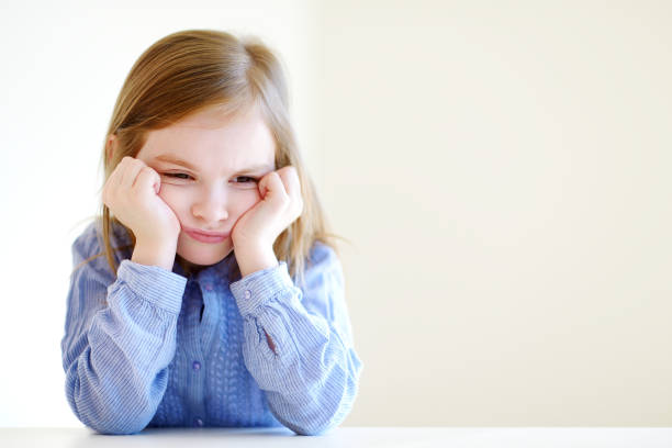 Little angry or bored girl portrait stock photo