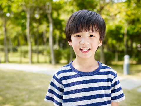 outdoor portrait of a little asian boy.