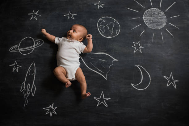 Little astronaut Baby super hero flying in space chalkboard visual aid photos stock pictures, royalty-free photos & images