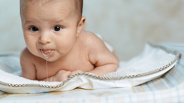 little beautiful baby drools stock photo