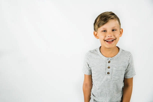 Little boy age 6 with autism on a white background with lots of copy space stock photo
