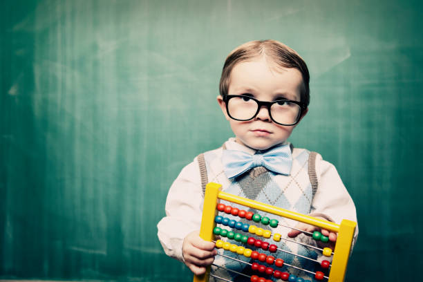 Little Boy Dressed as Acccountant using Abacus This little guy will put your books in the black. abacus stock pictures, royalty-free photos & images