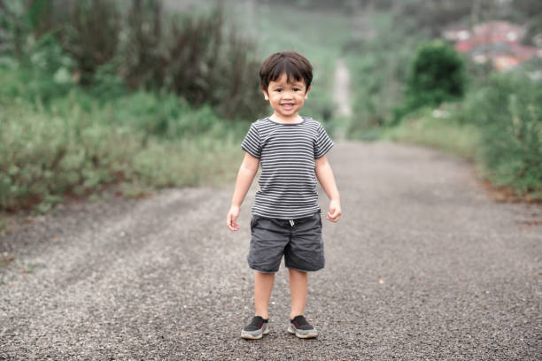 Little boy exploring the wild during his family hiking activity stock photo