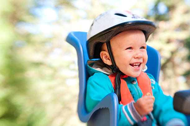 Little boy in bike child seat happy laughing stock photo