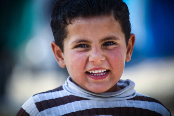 little boy in refugee camp stock photo