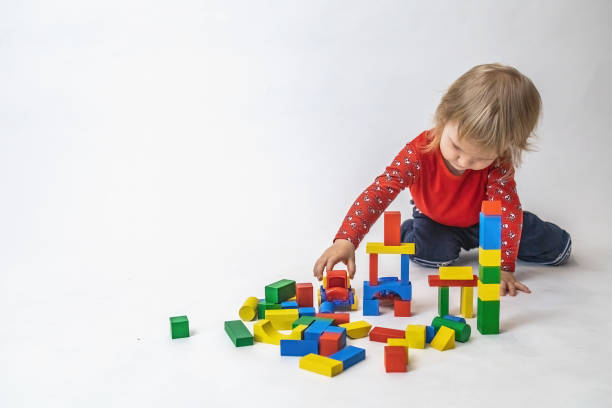 Little boy is playing with cubes stock photo