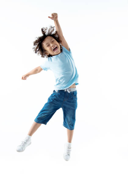 Little boy jumping isolated on white background  boy jumping stock pictures, royalty-free photos & images