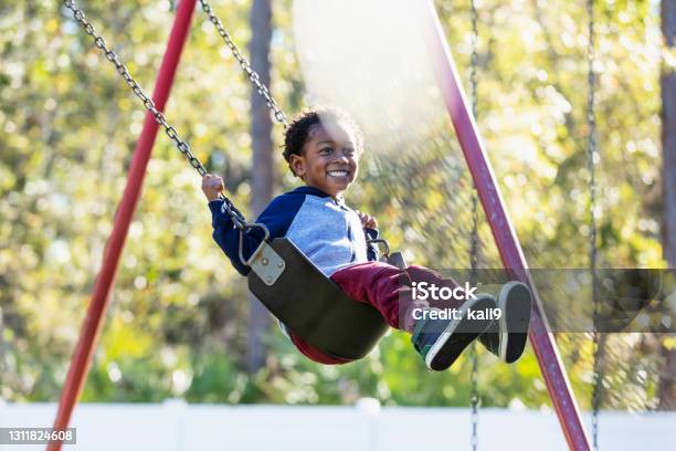 Little boy on playground swing