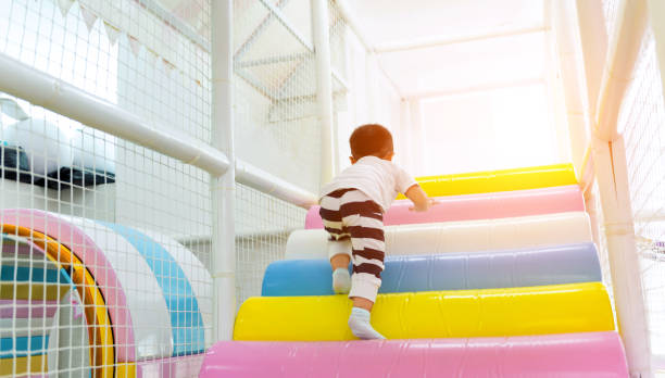 Little boy playing on obstacle course Little boy playing on obstacle course. indoor playground stock pictures, royalty-free photos & images