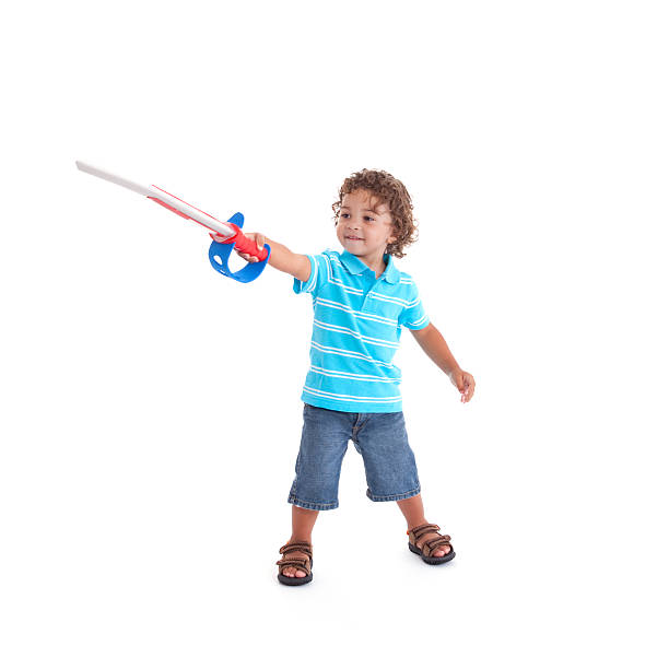 LIttle Boy Playing With Toy Sword stock photo