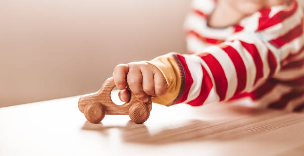 Little boy playing with wood car indoor stock photo
