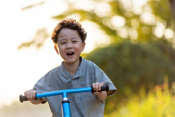 A little boy riding a bicycle stock photo