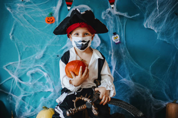 Little boy wearing Halloween costume and protective face mask during Covid-19 pandemic  costume stock pictures, royalty-free photos & images