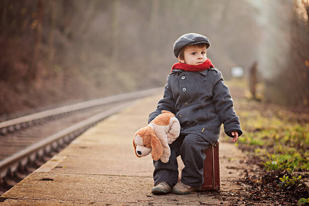 little boy with a suitcase and teddy toy - teddy ray stok fotoğraflar ve resimler
