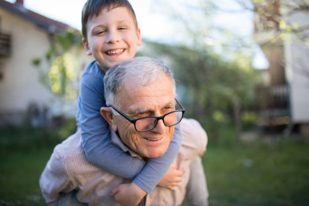 Little boy with his grandfather Little boy with his grandfather having fun outdoor real people stock pictures, royalty-free photos & images