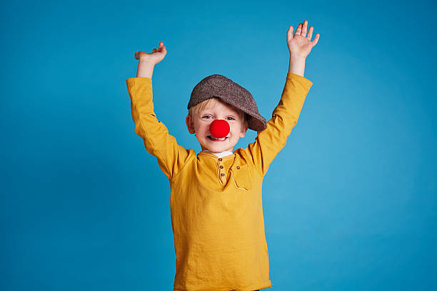 Little clown Portrait of a boy with clown nose clown's nose stock pictures, royalty-free photos & images