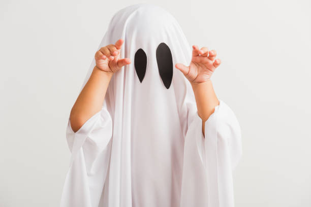 little cute child with white dressed costume halloween ghost scary Funny Halloween Kid Concept, little cute child with white dressed costume halloween ghost scary, studio shot isolated on white background ghost boy stock pictures, royalty-free photos & images