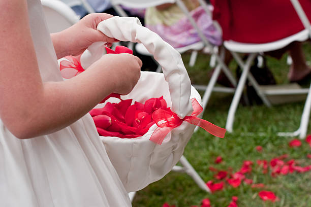 Little Flower Girls Tossing Rose Petals During Wedding Ceremony stock photo