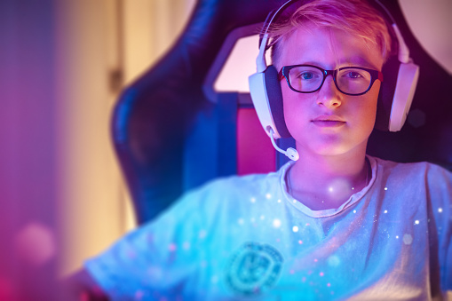Little gamer in headset near compute