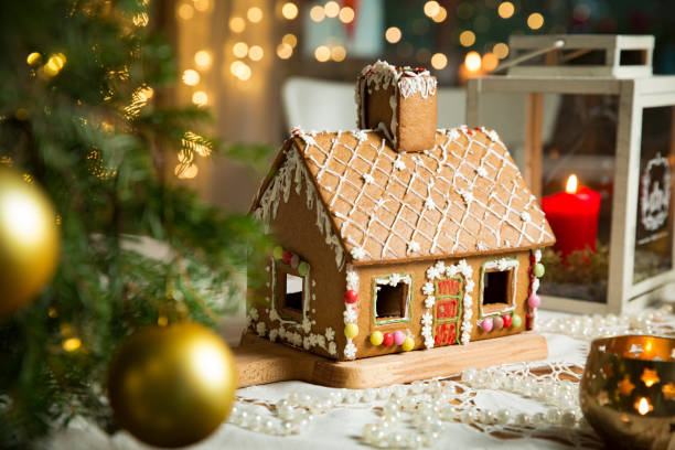 Little gingerbread house with glaze standing on table stock photo