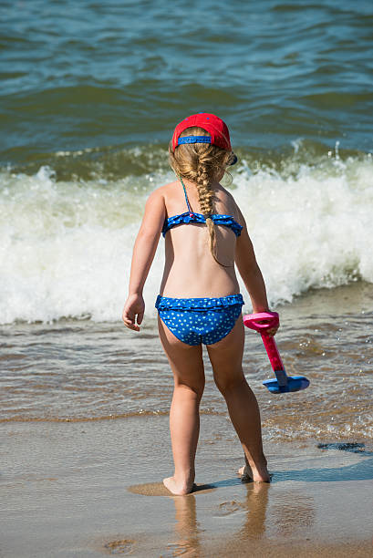 Little girl and sea waves stock photo