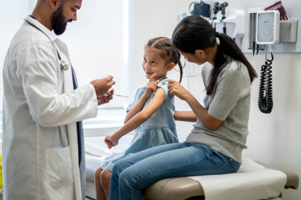 Little girl at a doctor's office for a vaccine injection stock photo