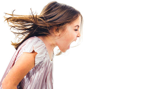 Little girl child yelling, shouting and screaming with bad manners. stock photo