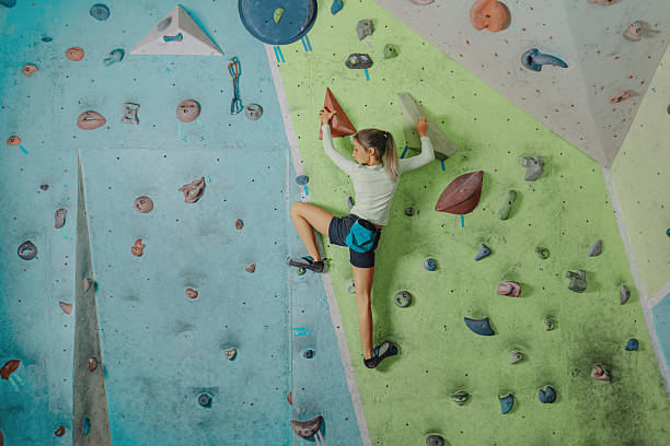 Little girl climbing in gym stock photo