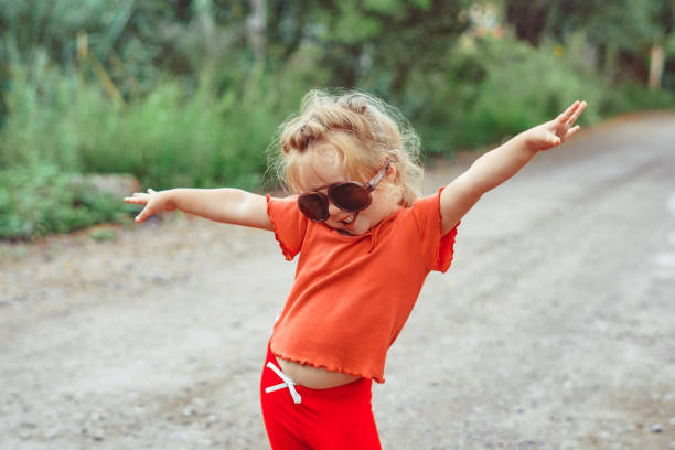 little girl dancing in glasses stock photo