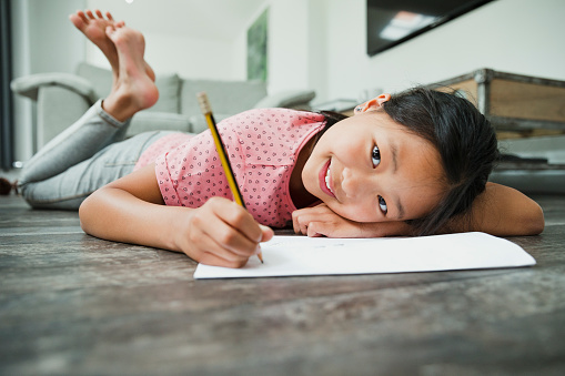 Portrait Of Little Cute Girl Doing Homework Stock Photo 