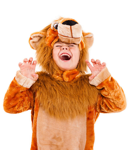 A little girl dressed up in a lion costume Pretty little girl costumed and acting like a lion  stage costume stock pictures, royalty-free photos & images