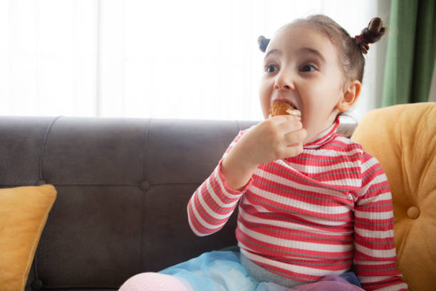 Little girl eating cake Little girl eating cake cute turkey cupcakes stock pictures, royalty-free photos & images