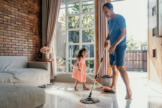 little girl help her daddy to do chores little girl help her daddy to do chores at home home cleaning stock pictures, royalty-free photos & images