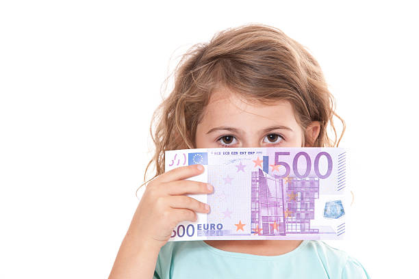 Little girl holding 500 euro stock photo