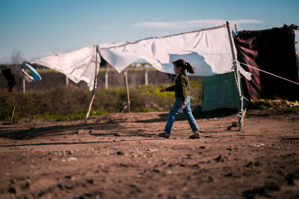 little girl in refugee camp stock photo