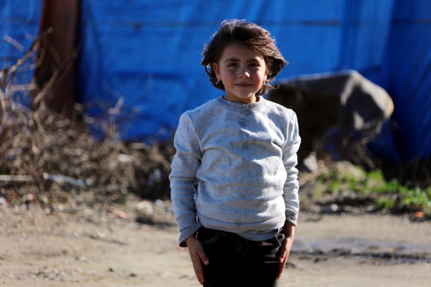 little girl in refugee camp stock photo